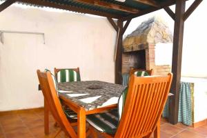 a dining room with a table and chairs and a fireplace at LA CUEVA de TONI EL SECO in Paterna