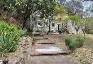 a stone house with steps in front of it at Villa ai Sugheri in Deiva Marina