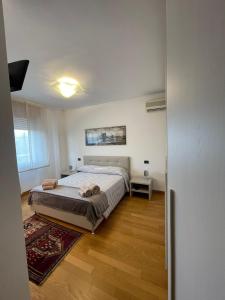 a bedroom with a large bed and a wooden floor at Apartment Donatello in Mestre