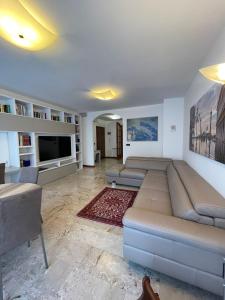 a living room with a large couch and a tv at Apartment Donatello in Mestre