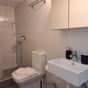 a bathroom with a toilet and a sink and a shower at BaSiLiKoS in Perdika