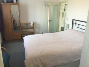 a bedroom with a bed and a dresser and a mirror at HH Accommodation in Millom
