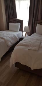 En eller flere senge i et værelse på Sawsana Villalari