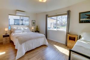 a bedroom with a large bed and a window at Waterfront Lakeport Rental Home with Private Dock! in Lakeport