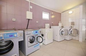 a laundry room with three washing machines and a washer and dryer at Premium mobile home FJAKA - Oaza Mira Camping Croatia in Drage