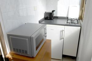 a small kitchen with a microwave and a refrigerator at Saint Peter Apartment in Rome