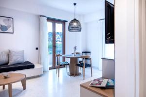 een woonkamer met een tafel en een bank bij ELMARAL living experience "Adults Only" in Agia Pelagia