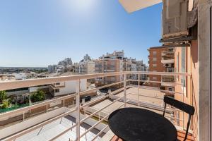 a balcony with a table and a view of the city at Shinning View Apartment in Armação de Pêra