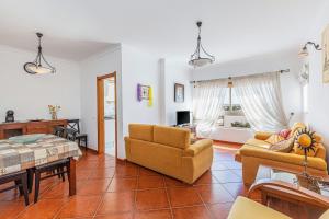 ein Wohnzimmer mit 2 Stühlen und einem Tisch in der Unterkunft Shinning View Apartment in Armação de Pêra