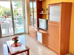 a living room with a large entertainment center with a television at APARTBEACH LARIMAR MUY LUMINOSO y CLIMATIZADO in Salou