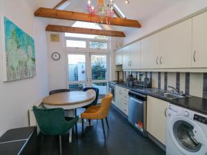 a kitchen with a table and a laundry room at 83 Upper John Street in Wexford