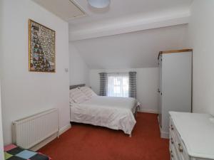 a white bedroom with a bed and a window at 83 Upper John Street in Wexford