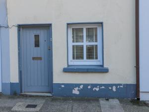 a blue door and a window on a white building at 83 Upper John Street in Wexford
