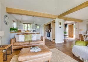a living room with a couch and a table at Bewl Water View in Ticehurst