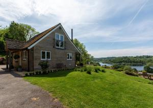 a house on a hill with a green yard at Bewl Water View in Ticehurst