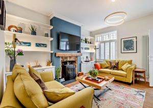 a living room with a couch and a fireplace at Beachtown Cottage in Broadstairs