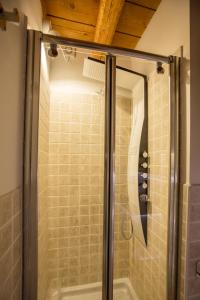 a shower with a glass door in a bathroom at Kate's Home in Udine