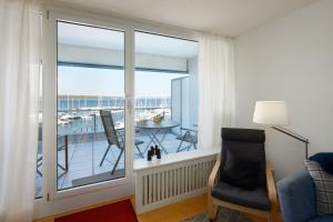 a room with a large window with a view of a balcony at BRN Bootsmann in Laboe