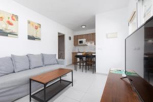 un soggiorno con divano e tavolo di Home2Book Charming Sun & Dunes Apartment a Corralejo