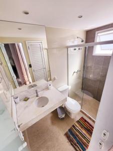 a bathroom with a sink and a toilet and a shower at Cobertura em Ondina in Salvador