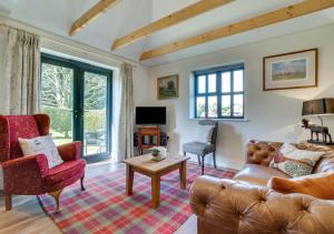 a living room with a couch and a table at 2 Hilltop Cottages in Stansted