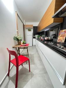 a kitchen with a red chair and a table at Residence Kyrenia in Kyrenia