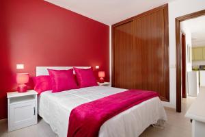 a red bedroom with a large bed with red walls at Casa Candido in Playa Honda