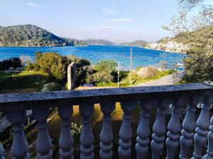 a balcony with a view of the water at Apartments Patricija in Polače