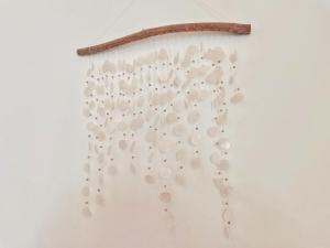 a wall with a bunch of white shells on it at Boho Garden Guest House in Mirissa