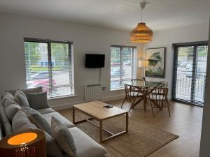 uma sala de estar com um sofá e uma mesa em 2 Bedroom Apartment Central Town Location em Enniscorthy