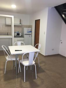 a white table and chairs in a kitchen at departamentos bv m in San Pedro