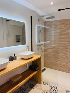 a bathroom with two sinks and a glass shower at La maison rue Nadaud, au pied des remparts in Carcassonne +29 photos