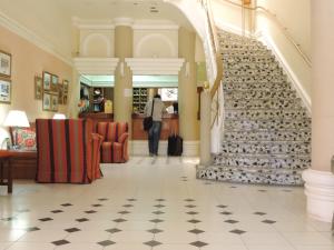 a person walking down a staircase in a building at Hotel Galicia in Trelew