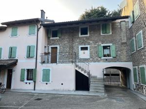 a building with a gate and stairs in front of it at Kate's Home in Udine