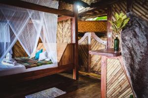 a room with a bed in a tree house at Secret Villa in La Digue