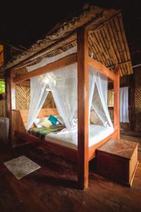 a bed with mosquito netting on it in a room at Secret Villa in La Digue