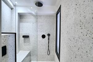 een douche met een glazen deur in de badkamer bij ELMARAL living experience "Adults Only" in Agia Pelagia