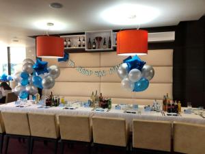 a table with blue and white balloons in a room at Hotel Dream in Sofia