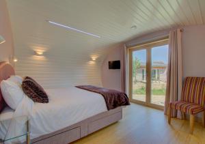 - une chambre avec un lit et une grande fenêtre dans l'établissement Bumble Barn, à Lyminge