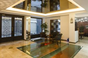 a living room with a glass table and chairs at P Galata Hotel - Special Category in Istanbul +60 photos