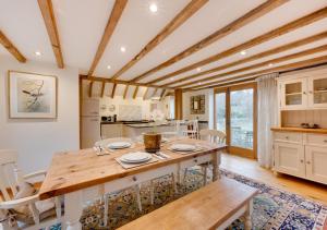 a kitchen with a large wooden table and chairs at Birdsong Barn in Westfield