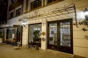 a store front with doors and tables and chairs at P Galata Hotel - Special Category in Istanbul