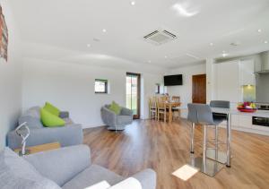 a living room with a couch and a table at Brighton Hopper Hut in Goudhurst