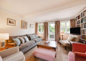 a living room with a couch and a table at Church Cottage in Barham