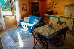 een woonkamer met een blauwe bank en een tafel bij Casa Elsa Terrazza con vista by ItalianHost in Maiori