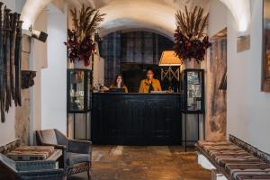 a man and a woman standing at a bar at AlmaLusa Baixa/Chiado in Lisbon