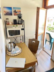 a kitchen with a table with a laptop on it at Guest house Hei Taka in Sozopol