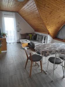 a living room with a table and a couch at Dorina Apartman in Zalakaros