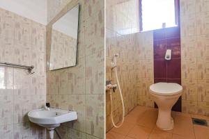 FabExpress Shraddha Boutique في بورفوريم: حمام مع مرحاض ومغسلة ومرآة