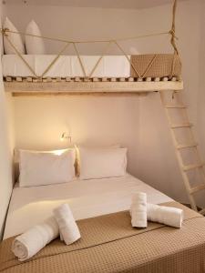 a bedroom with a bunk bed with two towels at Stavros Residence in Mármara
